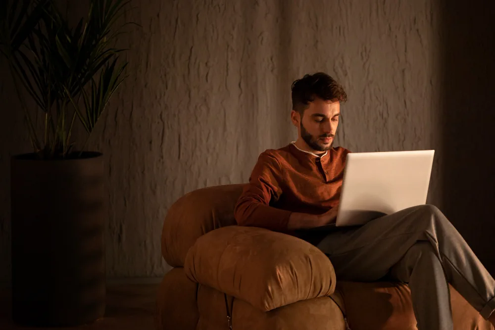 Man using laptop at home for mental health support